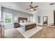 Comfortable main bedroom with hardwood floors, a ceiling fan, and large windows offering a bright and airy feel at 2816 Woodlands Creek Dr, Monroe, NC 28110