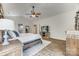 Well-lit main bedroom with a ceiling fan, hardwood floors, neutral decor, and an ensuite bathroom entrance at 2816 Woodlands Creek Dr, Monroe, NC 28110