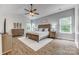 Bright main bedroom featuring vaulted ceilings, hardwood floors, and ample natural light from large windows at 2816 Woodlands Creek Dr, Monroe, NC 28110