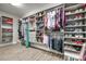 Large walk-in closet featuring custom shelves, hanging racks, drawers, and hardwood-style flooring at 2816 Woodlands Creek Dr, Monroe, NC 28110