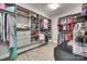 Spacious walk-in closet with custom shelving, hanging racks, drawers, and luxury vinyl flooring at 2816 Woodlands Creek Dr, Monroe, NC 28110