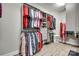 Organized walk-in closet with custom shelves, rods, drawers, and luxury vinyl plank flooring at 2816 Woodlands Creek Dr, Monroe, NC 28110