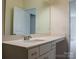 Bathroom featuring a long vanity, large mirror, and door to another room at 2921 Parkwest Dr, Albemarle, NC 28001