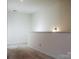 Bonus room offers neutral walls and carpet, a half wall, and a sconce at 2921 Parkwest Dr, Albemarle, NC 28001