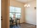 Cozy breakfast nook features a modern chandelier and a sunlit window at 2921 Parkwest Dr, Albemarle, NC 28001