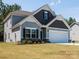 Stylish home showcasing modern architecture with a two-car garage and lush front yard at 2921 Parkwest Dr, Albemarle, NC 28001
