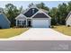 Charming two-story home with a two-car garage and well-manicured lawn at 2921 Parkwest Dr, Albemarle, NC 28001