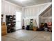 Large garage with clean concrete flooring, ample storage space, and a convenient entrance door at 2921 Parkwest Dr, Albemarle, NC 28001