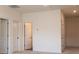 Hallway featuring multiple white doors and neutral walls and carpet at 2921 Parkwest Dr, Albemarle, NC 28001
