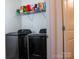 Convenient laundry room featuring modern washer and dryer units with wire shelving at 2921 Parkwest Dr, Albemarle, NC 28001