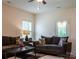 Inviting living room featuring plush sofas, modern ceiling fan, and natural light from a nearby window at 2921 Parkwest Dr, Albemarle, NC 28001