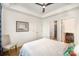 Bright bedroom featuring hardwood floors, a tray ceiling, and access to a bathroom at 3026 Kalex Ct, Charlotte, NC 28204