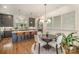 Eat-in kitchen and dining area boasts modern fixtures, a view of the kitchen, and a view of living space at 3026 Kalex Ct, Charlotte, NC 28204