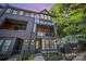 Multi-story townhome showcasing an exterior with balconies, brick accents, and a well-maintained yard at 3026 Kalex Ct, Charlotte, NC 28204