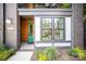Inviting entryway with modern brick, stylish trim, a green door, and large window at 3026 Kalex Ct, Charlotte, NC 28204