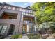 Stately three-story home featuring brick accents, balconies, and a well-manicured yard at 3026 Kalex Ct, Charlotte, NC 28204
