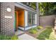 Charming entryway with a brick facade, wood accents, a green door, and landscaped garden at 3026 Kalex Ct, Charlotte, NC 28204