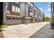 Row of townhomes featuring gray brick and gray garage doors at 3026 Kalex Ct, Charlotte, NC 28204