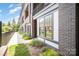 Modern home with a brick facade, well-kept lawn, and large windows at 3026 Kalex Ct, Charlotte, NC 28204