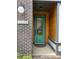 Inviting entryway featuring a vibrant green door, brick accents, and modern lighting fixture at 3026 Kalex Ct, Charlotte, NC 28204
