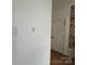Hallway with a white door, light switches, and artwork featuring One Piece anime characters on the wall at 3026 Kalex Ct, Charlotte, NC 28204