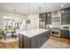 Open concept kitchen features a large island, stainless steel appliances, and gray cabinetry with plenty of storage at 3026 Kalex Ct, Charlotte, NC 28204