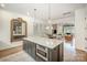 Modern kitchen island includes a microwave and seating area, opening to living area at 3026 Kalex Ct, Charlotte, NC 28204