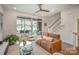 Living room features plush seating, sliding glass doors to balcony, and staircase at 3026 Kalex Ct, Charlotte, NC 28204