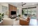 Cozy living room has plush seating, modern wood paneled wall, and a sliding door to a patio at 3026 Kalex Ct, Charlotte, NC 28204