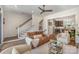 Bright living room with a staircase and an open view of a modern kitchen with stainless appliances at 3026 Kalex Ct, Charlotte, NC 28204
