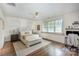 Bright main bedroom features hardwood floors, a ceiling fan, and sun-filled windows at 3026 Kalex Ct, Charlotte, NC 28204