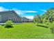 A spacious backyard with green lawn, trees, and privacy fencing at 3207 Selwyn Landing Dr, Charlotte, NC 28215
