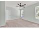 Bright bedroom with a ceiling fan, carpet flooring, and natural light from a large window at 3207 Selwyn Landing Dr, Charlotte, NC 28215