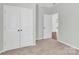 Bedroom with double closet, neutral carpet, and doorway to another room at 3207 Selwyn Landing Dr, Charlotte, NC 28215