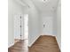 Bright entryway with hardwood floors, featuring a view into another room and white doors at 3207 Selwyn Landing Dr, Charlotte, NC 28215
