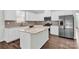 Modern kitchen featuring white cabinets, stainless steel appliances, a large island, and granite countertops at 3207 Selwyn Landing Dr, Charlotte, NC 28215