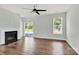 Bright living room with hardwood floors, a fireplace, ceiling fan, and sliding glass doors at 3207 Selwyn Landing Dr, Charlotte, NC 28215