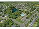 Aerial view showcasing the community pool, lush greenery, pond, and neighborhood streets at 321 Almora Loop, Mooresville, NC 28115