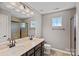 Bathroom featuring double sinks, a vanity with dark wood cabinets, shower, and natural light at 321 Almora Loop, Mooresville, NC 28115