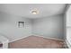 This cozy bedroom features neutral walls, carpet flooring, and natural lighting at 321 Almora Loop, Mooresville, NC 28115