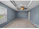Spacious bedroom with a tray ceiling, ceiling fan, and ample natural light from a large window at 321 Almora Loop, Mooresville, NC 28115