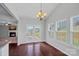 Inviting dining area adjacent to a cozy fireplace, complete with hardwood floors and ample natural light at 321 Almora Loop, Mooresville, NC 28115