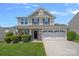 Charming two-story home with a two-car garage, landscaped yard, and inviting covered front porch at 321 Almora Loop, Mooresville, NC 28115