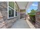 Inviting covered front porch featuring stone accents, white columns, and a well-maintained walkway at 321 Almora Loop, Mooresville, NC 28115