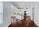 Open kitchen featuring white cabinets, an island with granite countertops, and stainless steel appliances at 321 Almora Loop, Mooresville, NC 28115