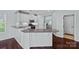 Bright kitchen featuring white cabinets, a peninsula, granite countertops, and stainless steel appliances at 321 Almora Loop, Mooresville, NC 28115