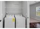 Convenient laundry room with shelving and a window for natural light at 321 Almora Loop, Mooresville, NC 28115