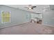 Open-concept living area showcasing plush carpeting, and seamless flow into the adjacent spaces at 321 Almora Loop, Mooresville, NC 28115