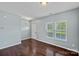 Open living room with hardwood floors, plenty of natural light, and fresh neutral paint at 321 Almora Loop, Mooresville, NC 28115