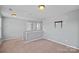 A bright and open loft area with neutral walls, carpet flooring and natural light at 321 Almora Loop, Mooresville, NC 28115